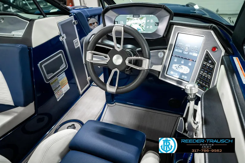 Slide: The Image of 2025 MasterCraft X24 boat interior with advanced dashboard and steering wheel. - 38