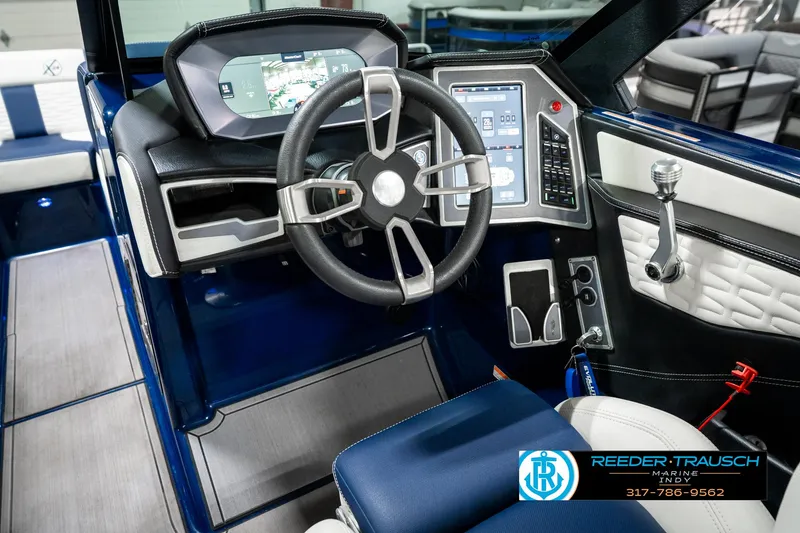 Slide: The Image of 2025 MasterCraft X24 boat cockpit with modern steering wheel and digital controls. - 39