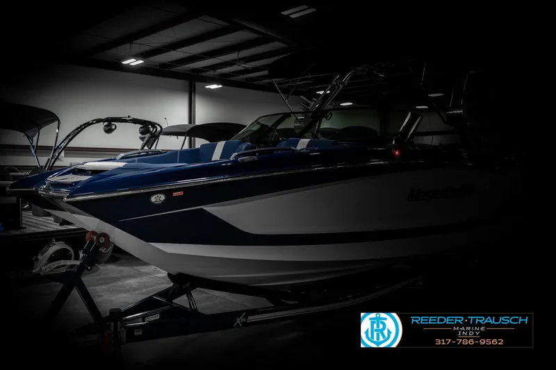 Slide: The Image of 2025 MasterCraft X24 boat in a dimly lit showroom, showcasing sleek design and modern features. - 4