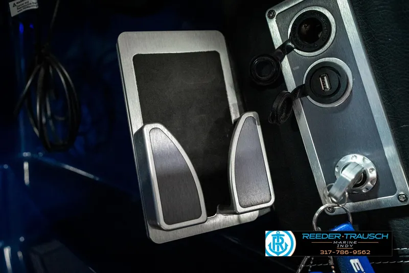 Slide: The Image of 2025 MasterCraft X24 dashboard with phone holder and ignition key. - 46