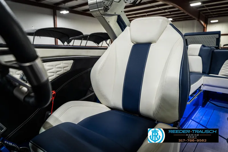 Slide: The Image of 2025 MasterCraft X24 boat interior with luxurious white and blue seating. - 47
