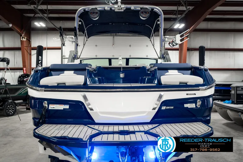 Slide: The Image of 2025 MasterCraft X24 boat in showroom with blue LED lighting. - 9