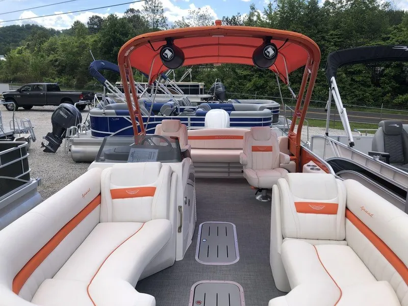 Slide: The Image of 2024 Bennington 24 LXSSBA pontoon boat with orange canopy and spacious seating. - 2