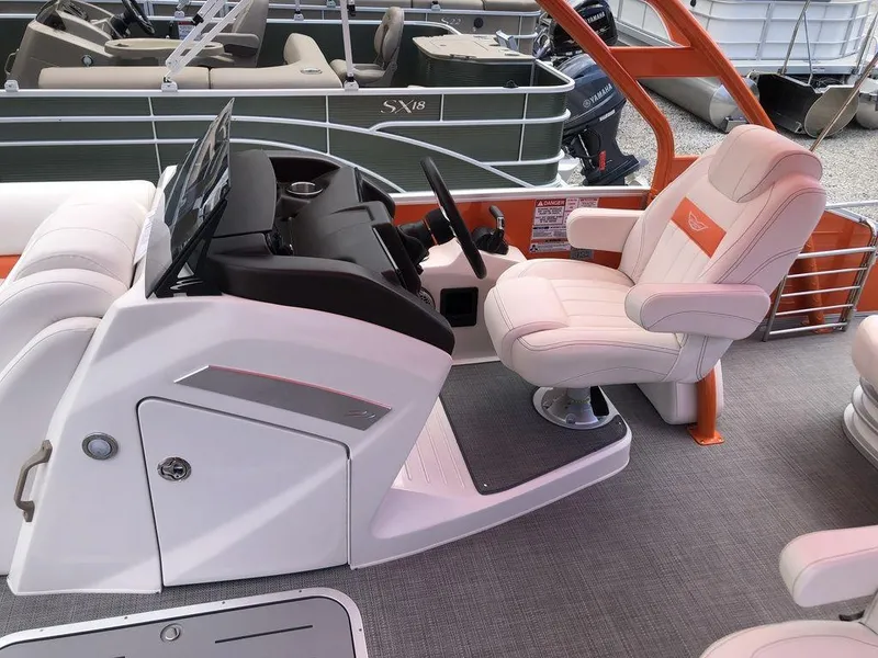 Slide: The Image of 2024 Bennington 24 LXSSBA boat interior with captain's chair and control console. - 4