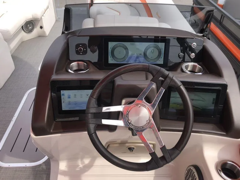 Slide: The Image of 2024 Bennington 24 LXSSBA boat dashboard with modern steering and digital displays. - 6
