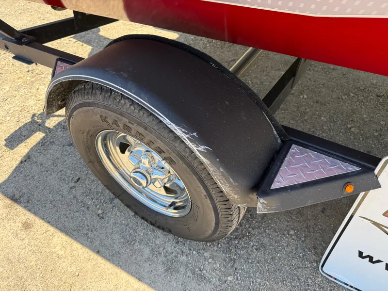 Slide: The Image of 2019 Tracker Pro Team 175 TXW trailer wheel with visible scratches on the fender. - 11