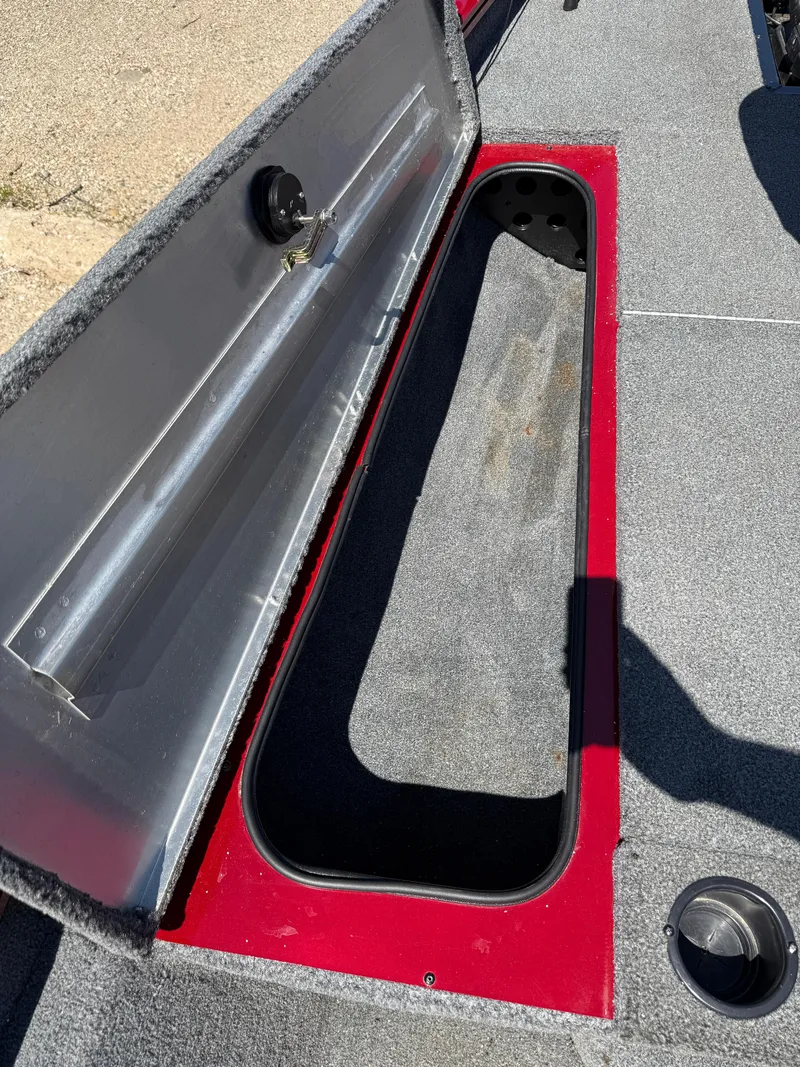Slide: The Image of 2019 Tracker Pro Team 175 TXW boat storage compartment with open lid, showing interior space. - 14