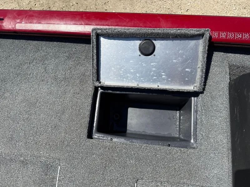 Slide: The Image of 2019 Tracker Pro Team 175 TXW storage compartment with open lid, showing interior space. - 20