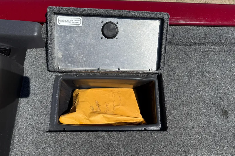 Slide: The Image of Storage compartment of 2019 Tracker Pro Team 175 TXW boat with an envelope inside. - 24