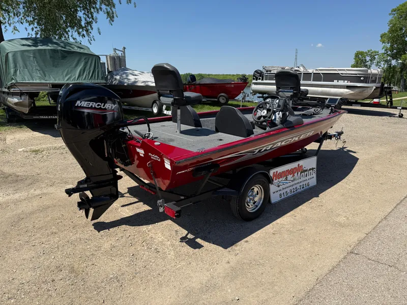Slide: The Image of 2019 Tracker Pro Team 175 TXW boat with Mercury engine, parked outdoors. - 7