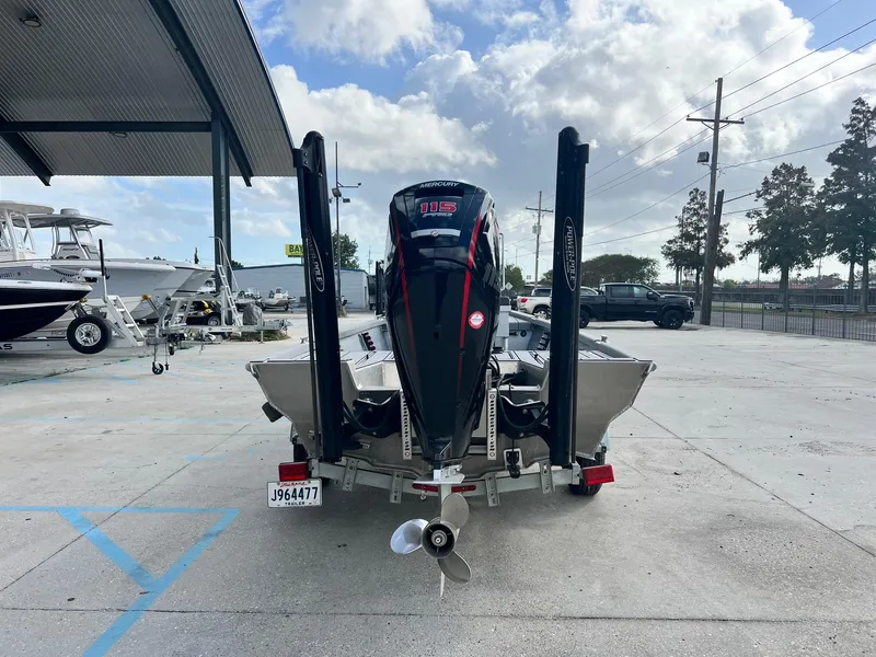 Slide: The Image of 2022 Hanko 185 CCLS boat with Mercury outboard motor on trailer, parked outdoors. - 3