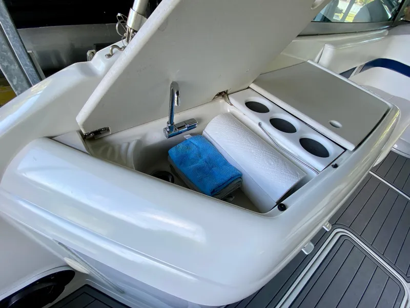 Slide: The Image of 2000 Formula 280 Bowrider boat interior with open storage compartment and cup holders. - 12