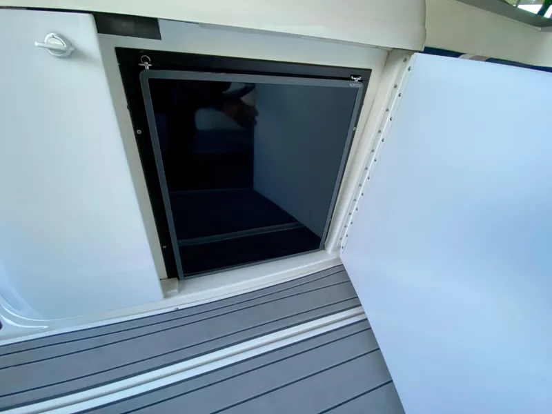 Slide: The Image of Open storage compartment on a 2000 Formula 280 Bowrider boat. - 13