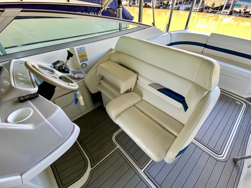 Slide: The Image of Interior of a 2000 Formula 280 Bowrider boat with white seating and steering wheel. - 16