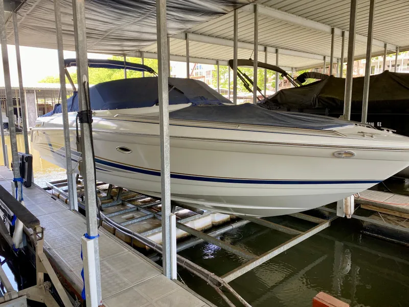 Slide: The Image of 2000 Formula 280 Bowrider boat docked under covered marina. - 2