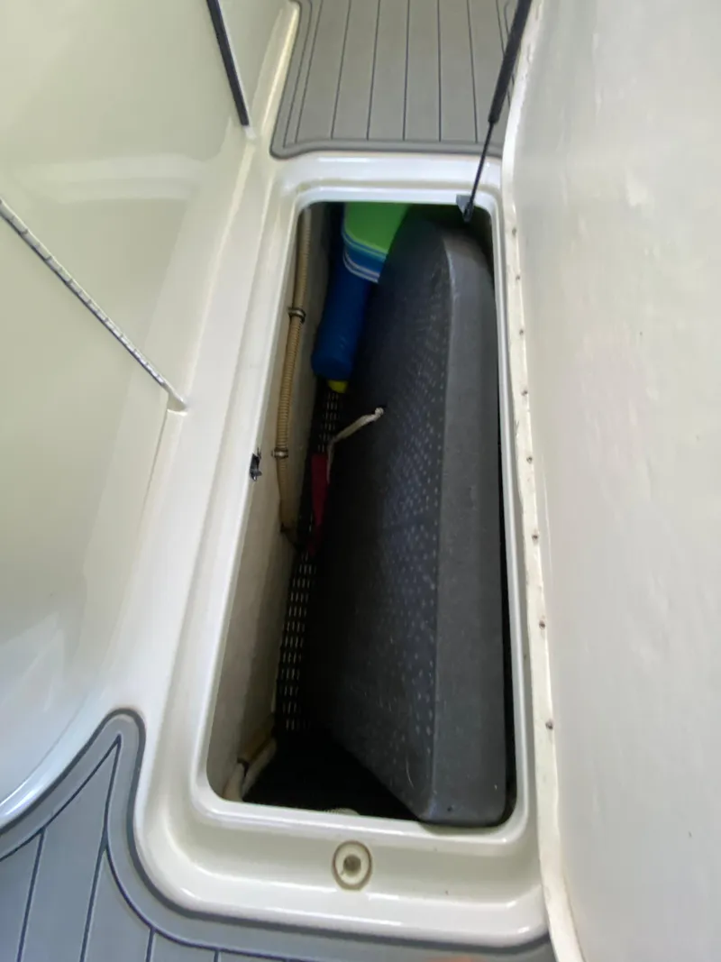 Slide: The Image of Storage compartment on a 2000 Formula 280 Bowrider boat, featuring a sleek interior design. - 24