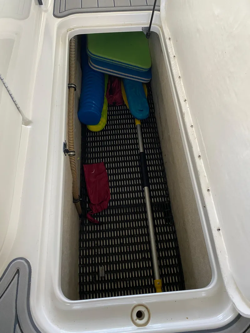 Slide: The Image of Storage compartment in a 2000 Formula 280 Bowrider boat with cushions and equipment. - 25