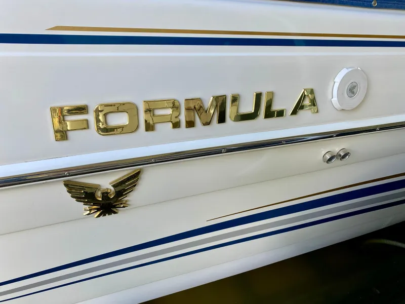Slide: The Image of 2000 Formula 280 Bowrider boat with gold lettering and emblem on white hull. - 26
