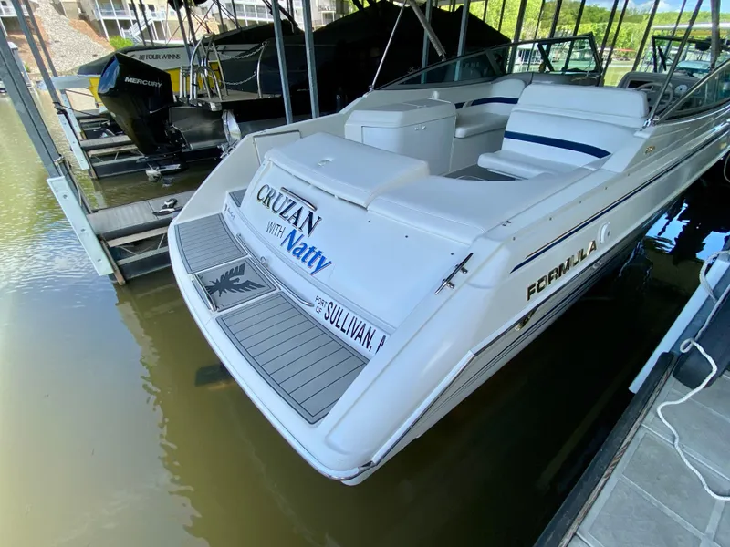 Slide: The Image of 2000 Formula 280 Bowrider boat docked, featuring spacious seating and sleek design. - 7