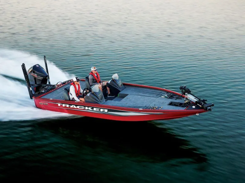 Slide: The Image of 2025 Tracker SAVAGE™ 215 boat speeding on water, featuring sleek red design and modern equipment. - 11