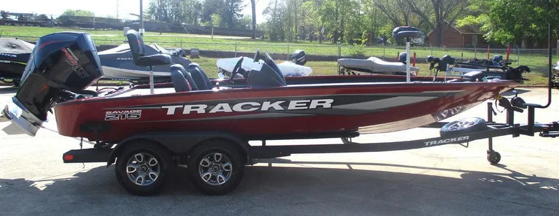 Slide: The Image of 2025 Tracker SAVAGE™ 215 boat on trailer, red and white design, parked outdoors. - 4