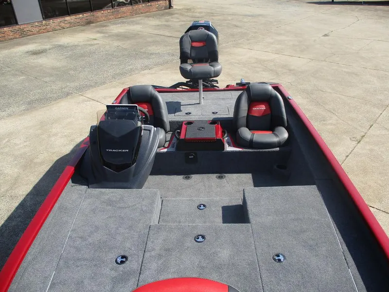 Slide: The Image of 2025 Tracker SAVAGE™ 215 boat interior with gray and red seating, spacious deck layout. - 9