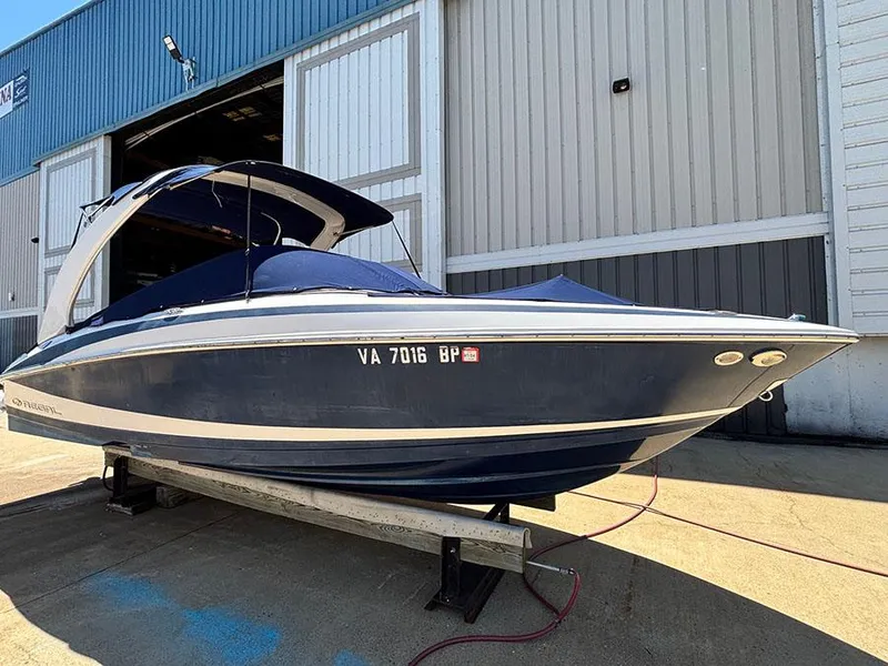 Slide: The Image of 2010 Regal 2300 RX Bowrider boat on trailer outside a warehouse. - 1
