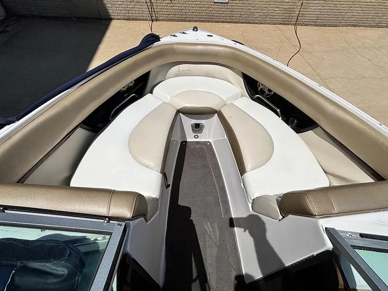 Slide: The Image of 2010 Regal 2300 RX Bowrider boat interior with beige and white seating. - 13