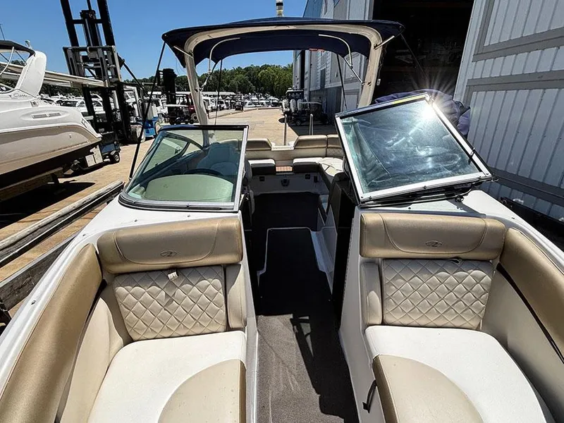 Slide: The Image of 2010 Regal 2300 RX Bowrider interior with beige seating and open windshield. - 14