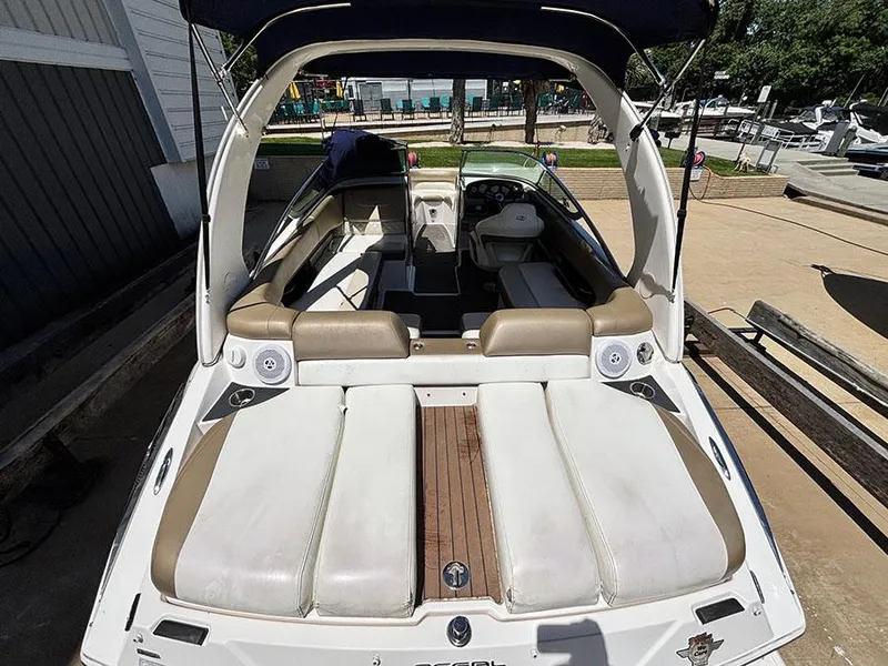 Slide: The Image of 2010 Regal 2300 RX Bowrider with spacious seating and sleek design, docked outdoors. - 5
