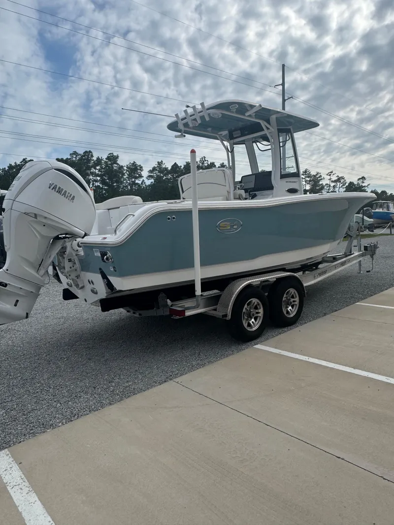 Slide: The Image of 2023 Sea Hunt Ultra 255 SE boat on trailer under cloudy sky. - 14