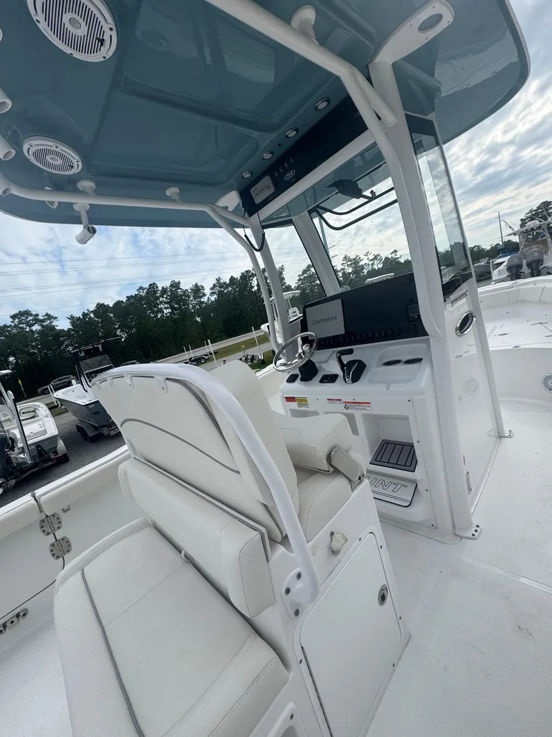 Slide: The Image of 2023 Sea Hunt Ultra 255 SE boat interior with helm and seating area. - 16