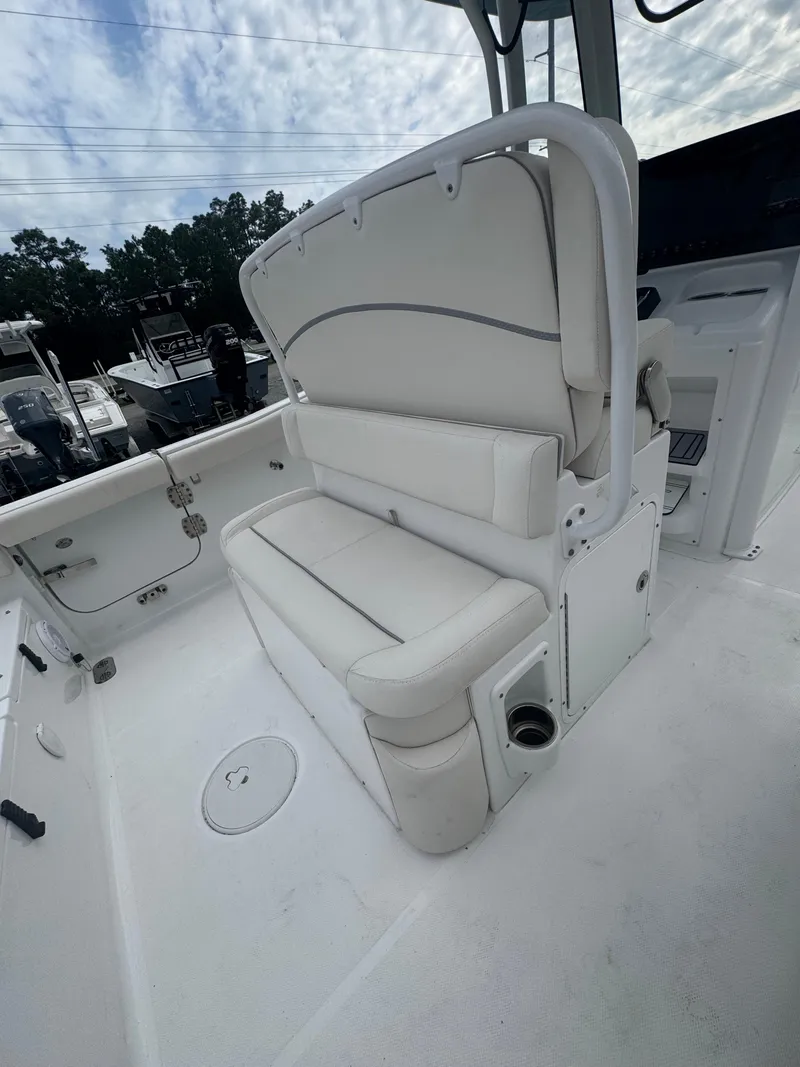Slide: The Image of 2023 Sea Hunt Ultra 255 SE boat interior with cushioned seating and storage. - 18