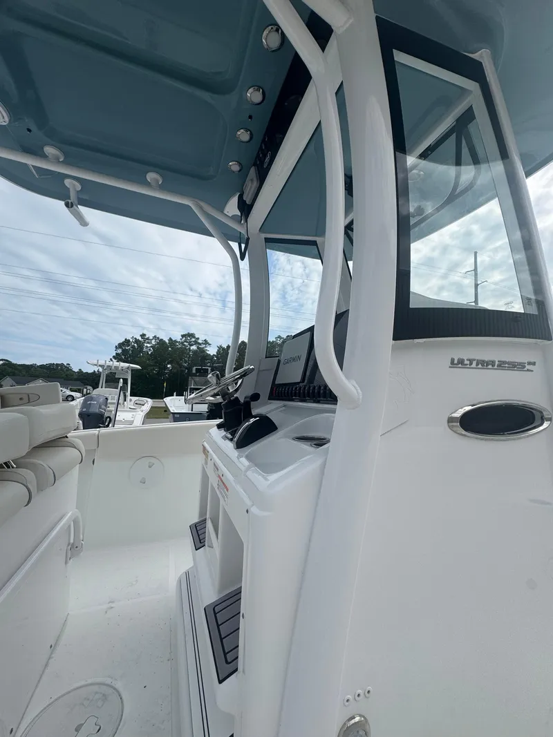 Slide: The Image of 2023 Sea Hunt Ultra 255 SE boat interior with console and seating. - 21