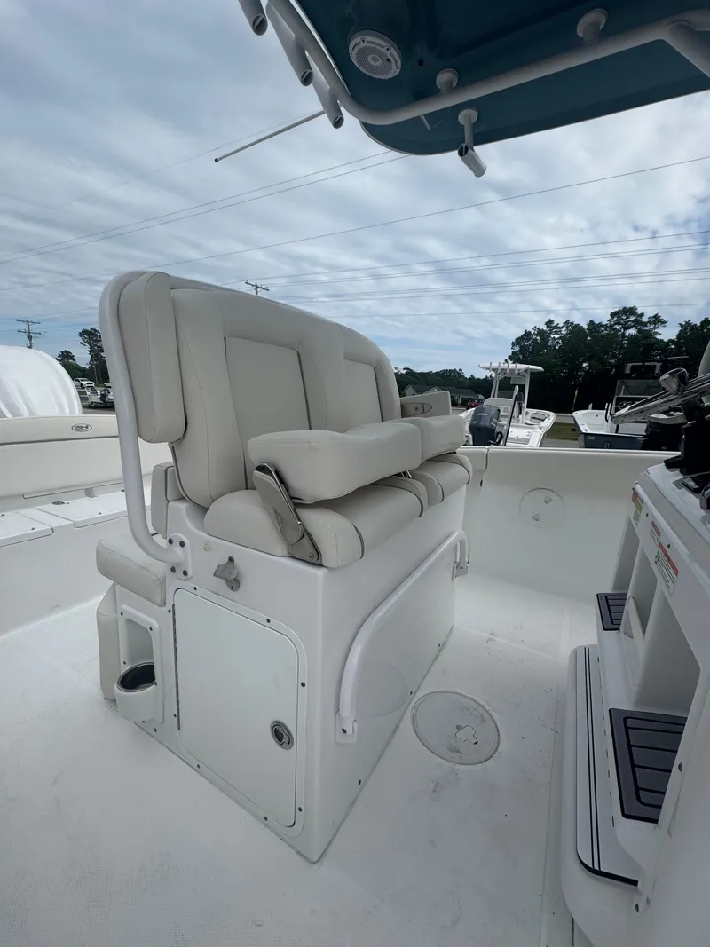 Slide: The Image of 2023 Sea Hunt Ultra 255 SE boat interior with cushioned seating and storage. - 22