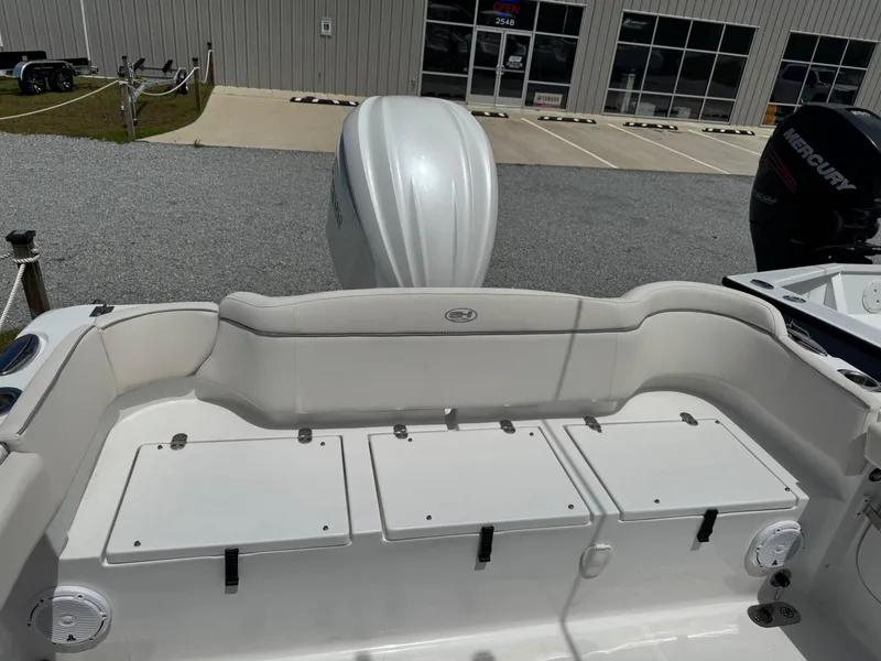 Slide: The Image of 2023 Sea Hunt Ultra 255 SE boat with white seating and storage compartments. - 6