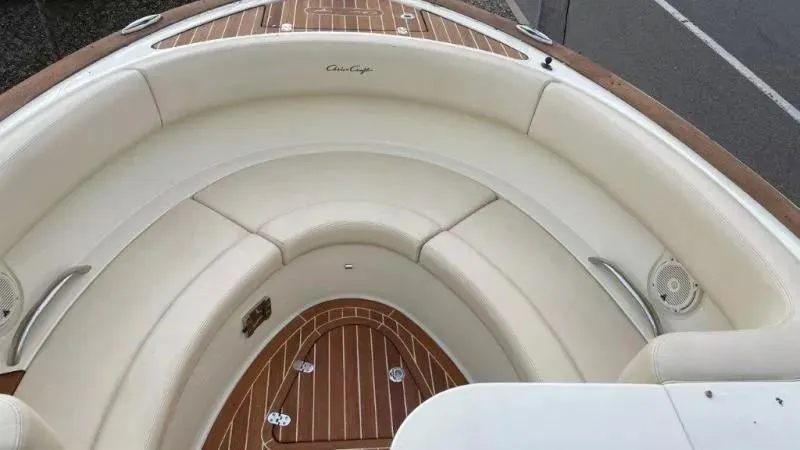 Slide: The Image of 2017 Chris-Craft Launch 28 boat interior with white seating and wooden flooring. - 15