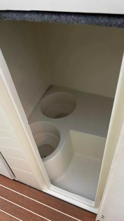 Slide: The Image of 2017 Chris-Craft Launch 28 storage compartment with cup holders, featuring a sleek interior design. - 17