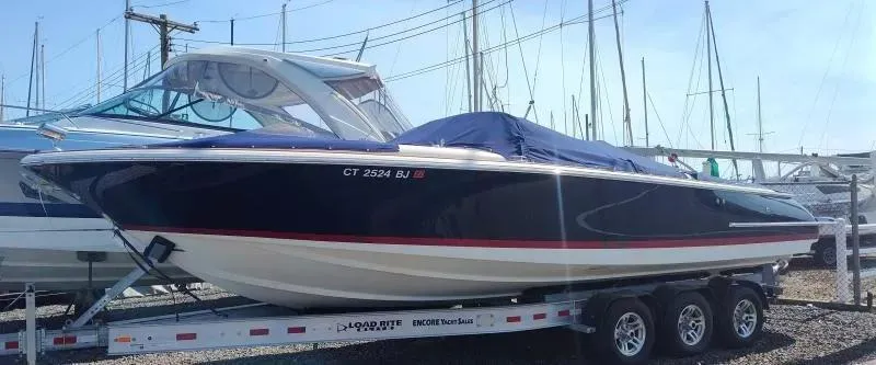 Slide: The Image of 2017 Chris-Craft Launch 28 boat on trailer, covered, in marina setting. - 2