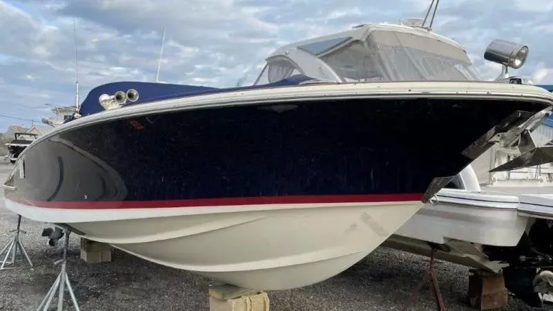 Slide: The Image of 2017 Chris-Craft Launch 28 boat on display, featuring sleek design and elegant navy hull. - 4