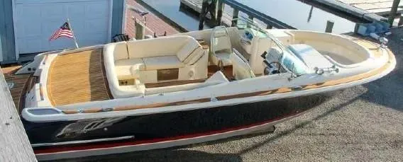 Slide: The Image of 2017 Chris-Craft Launch 28 boat docked, featuring elegant design and spacious seating. - 5