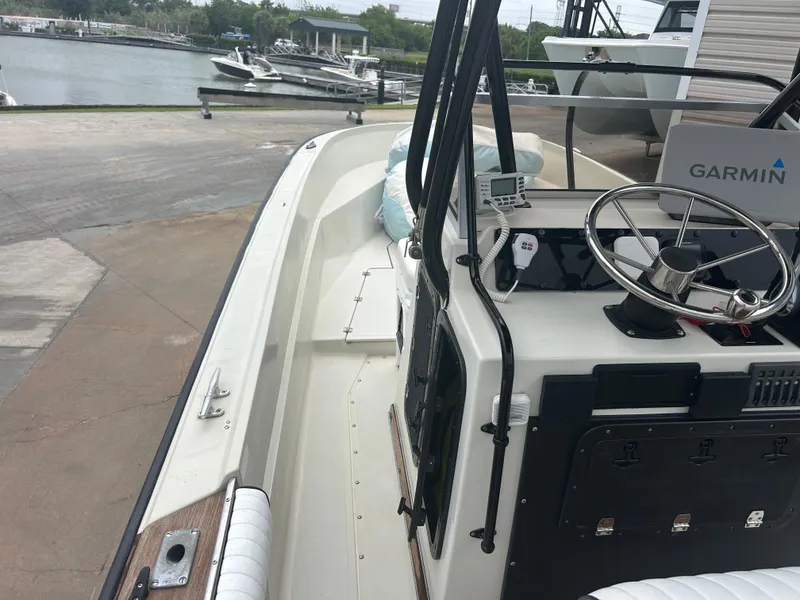Slide: The Image of 1983 Boston Whaler 25 Outrage boat with Garmin navigation, docked near a marina. - 10