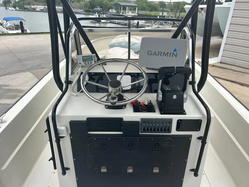 Slide: The Image of 1983 Boston Whaler 25 Outrage boat console with Garmin navigation system and steering wheel. - 11