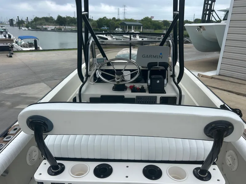 Slide: The Image of 1983 Boston Whaler 25 Outrage boat with Garmin navigation, docked near a marina. - 12