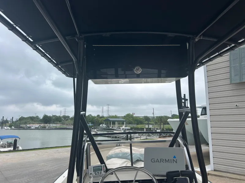 Slide: The Image of 1983 Boston Whaler 25 Outrage boat with Garmin equipment, docked near a waterfront. - 15