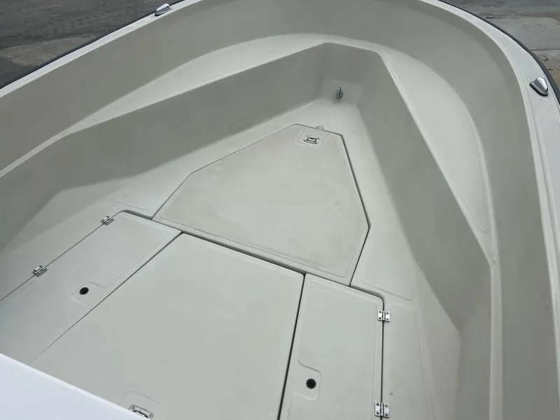 Slide: The Image of 1983 Boston Whaler 25 Outrage boat interior, showcasing spacious deck and storage compartments. - 16