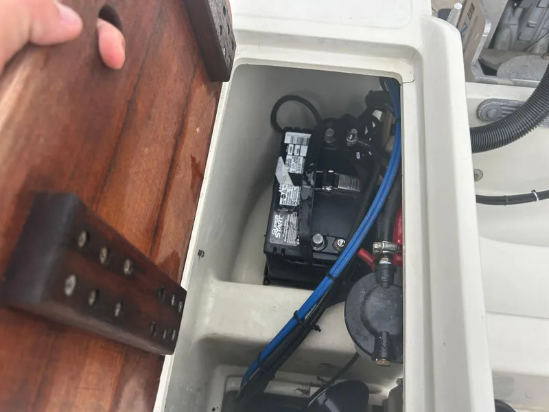 Slide: The Image of Battery compartment of a 1983 Boston Whaler 25 Outrage boat, showing wiring and components. - 21