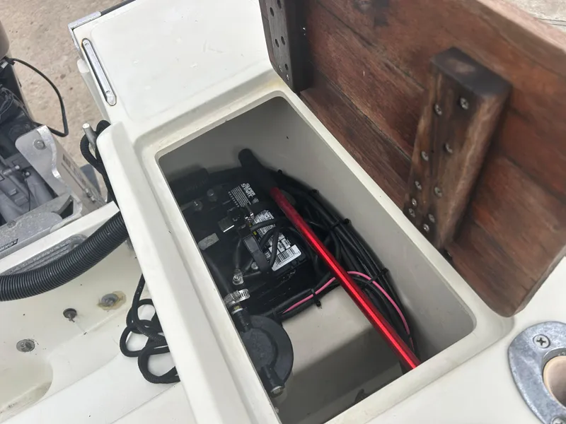 Slide: The Image of Battery compartment of a 1983 Boston Whaler 25 Outrage boat, showing wiring and storage. - 22