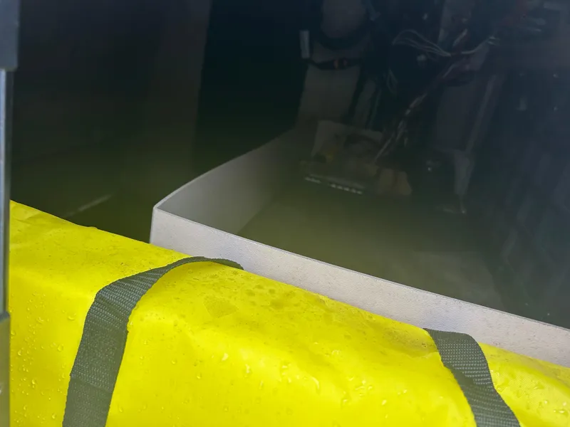 Slide: The Image of Interior view of a 1983 Boston Whaler 25 Outrage with a yellow life jacket. - 23