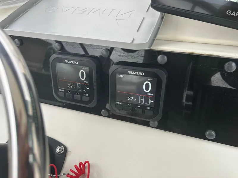 Slide: The Image of Dashboard of a 1983 Boston Whaler 25 Outrage with Suzuki digital displays. - 26